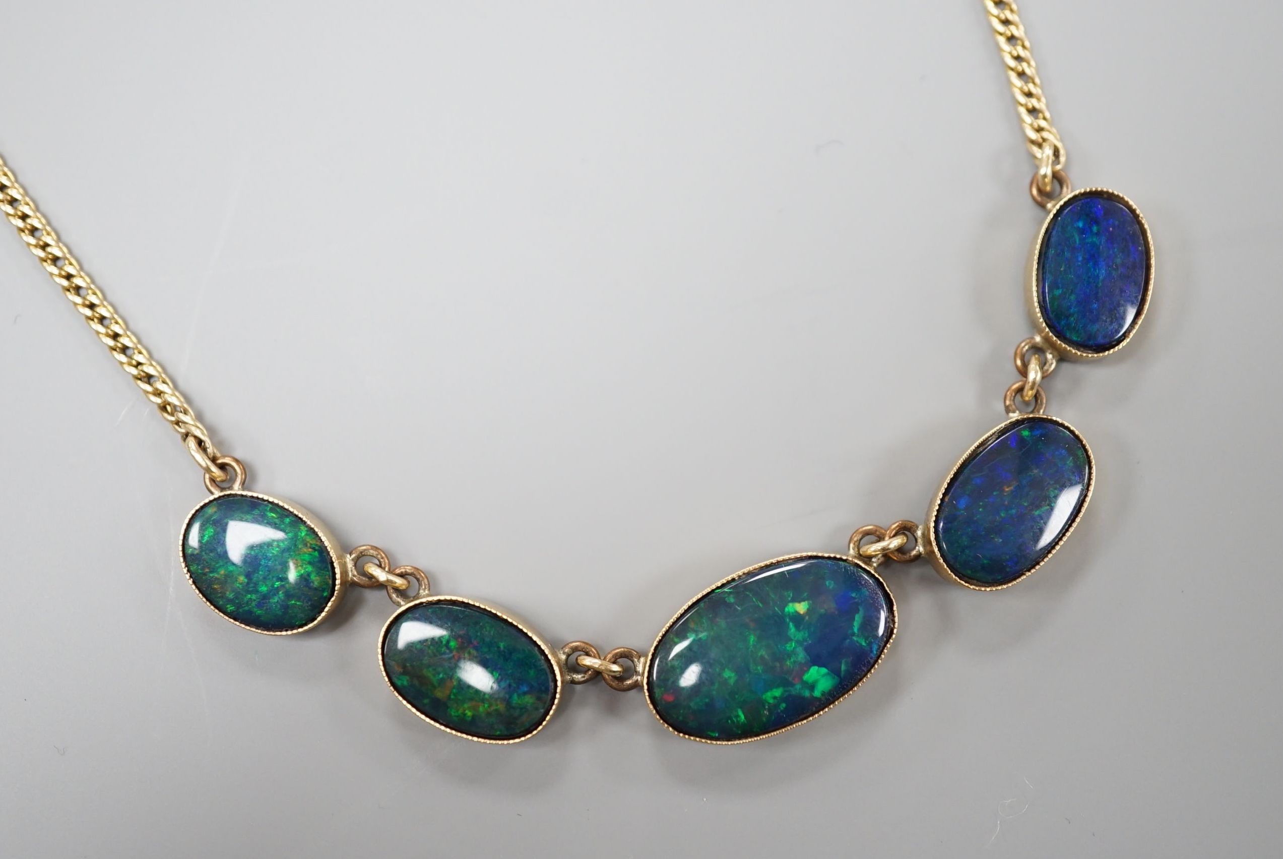 A yellow metal and graduated oval opal doublet set fringe necklace, 48cm, gross weight 14.1 grams.